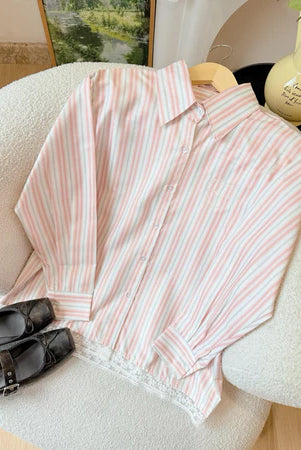Pink and white striped shirt by Haidee Orlin on a chair with a blurred background