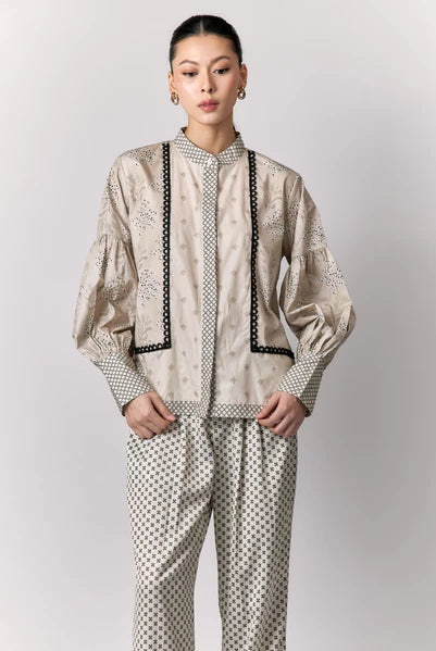 Person wearing a patterned shirt by Studio Tui on a plain background