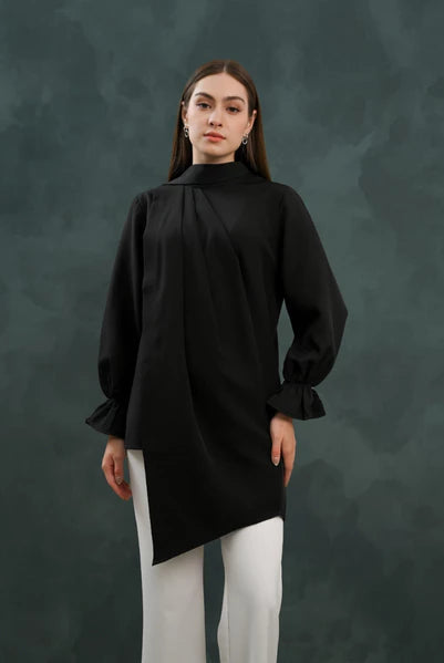 Person wearing a black blouse by Kasa Heritage with a high collar against a dark background