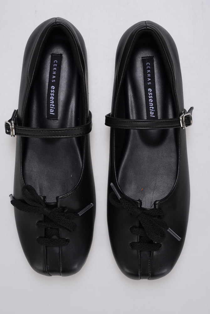 A pair of black Mary Jane ballet flatshoes by Cekhas with matching ribbon bows and small gold-tone buckle details, displayed on a light gray background.