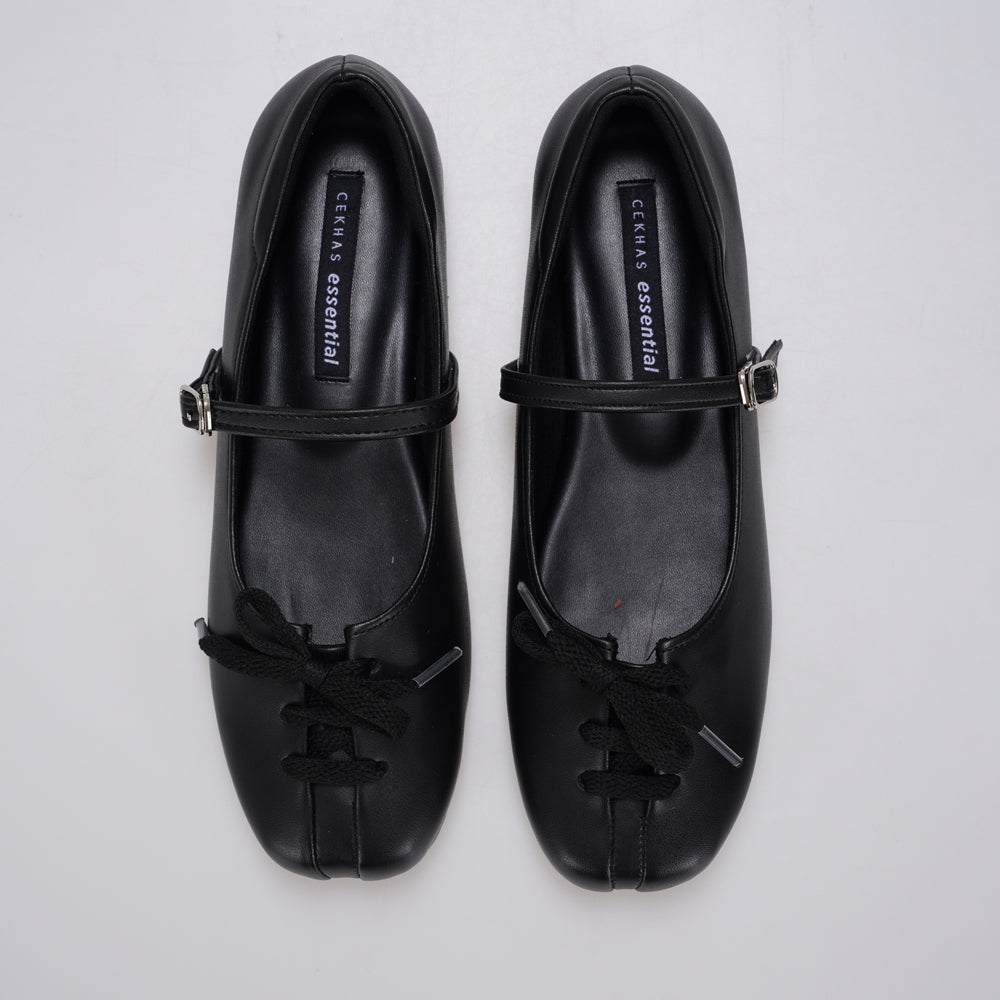 A pair of black Mary Jane ballet flatshoes by Cekhas with matching ribbon bows and small gold-tone buckle details, displayed on a light gray background.