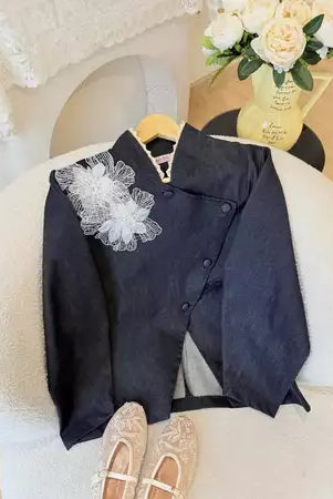 Black jeans blazer with white floral details by Haidee Orlin on a chair