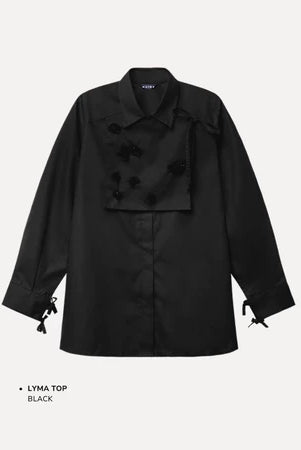 Black top by Maima with bow details on a light gray background