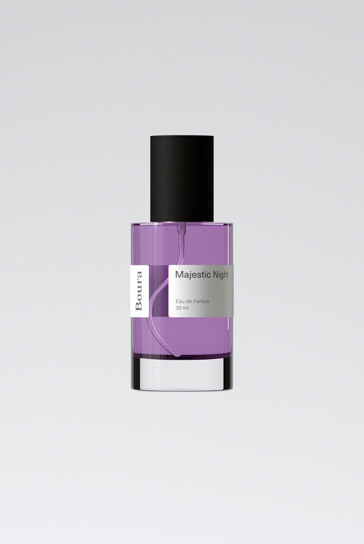 A bottle of Majestic Night perfume by Boura with a purple liquid and a clear glass container.