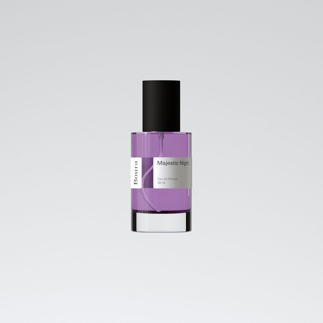 A bottle of Majestic Night perfume by Boura with a purple liquid and a clear glass container.