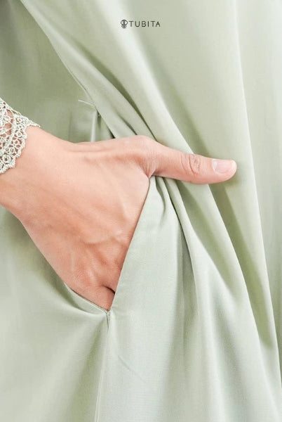 Light green abaya with lace-trimmed sleeve, TUBITA brand visible