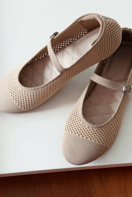 Pair of beige mesh ballerina flatshoes by Tutu Toe on a white surface
