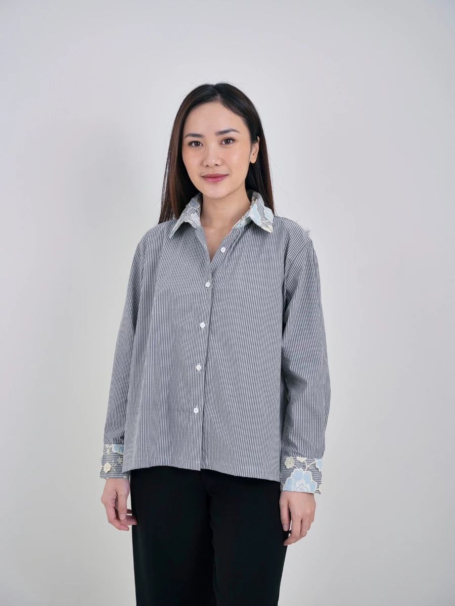 Woman wearing a gray patterned shirt by Studio Tui on a white background