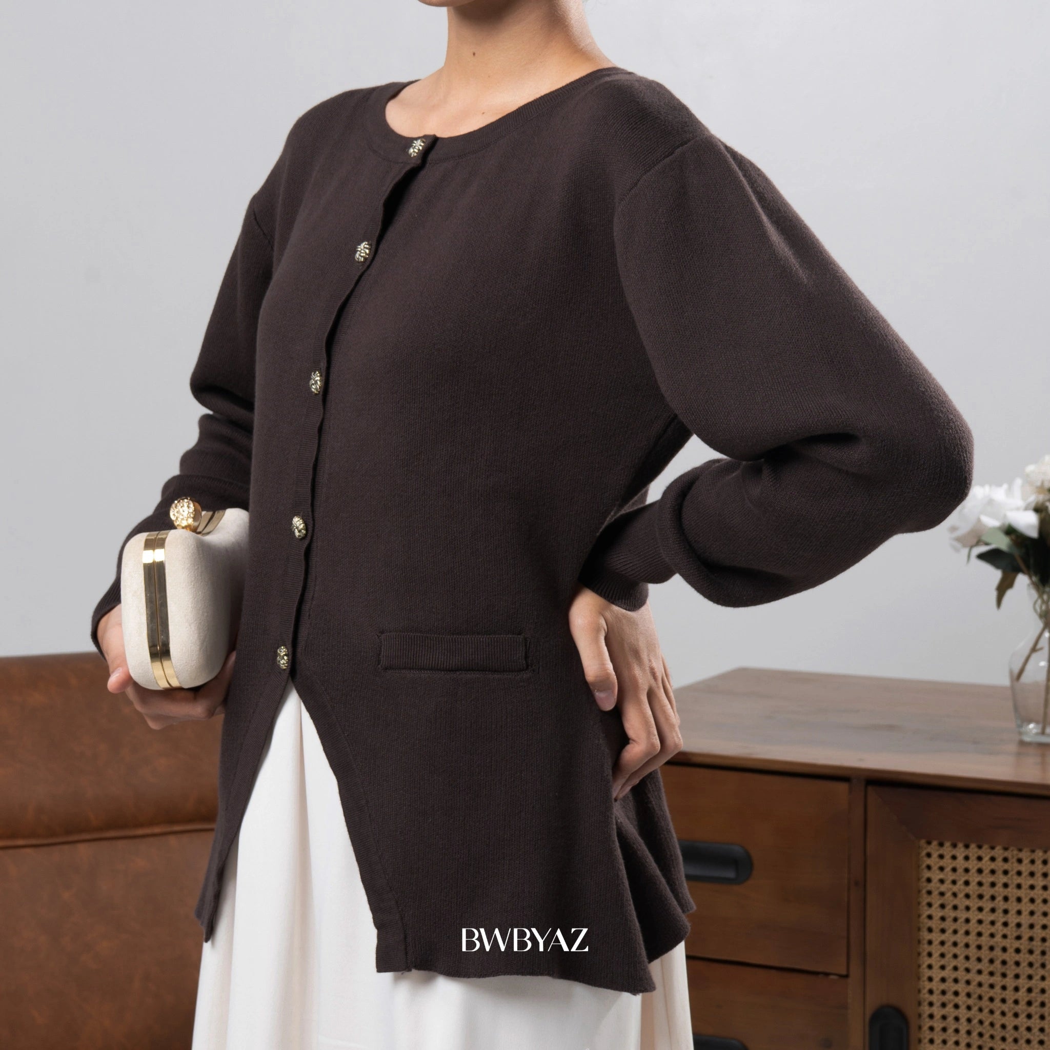 Person wearing a dark brown cardigan from BWBYAZ with a blurred background