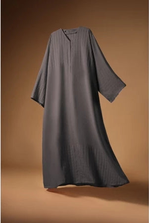 Gray Mecca Dhurma Abaya by Nehhat Modest on a brown background