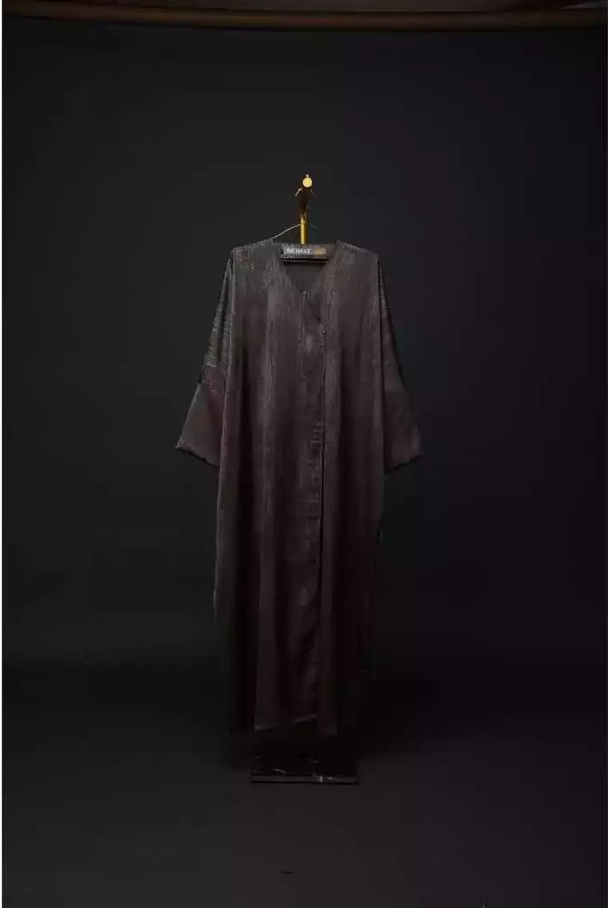 Long dark outer robe by Nehhat Modest on a hanger against a black background