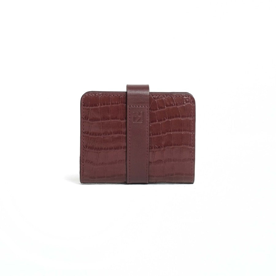 A closed brown bifold wallet from purotti with a textured surface, displayed against a solid background.
