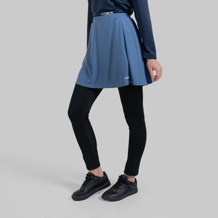Person wearing a stone blue seraphina skirt pro from Noore on a gray background