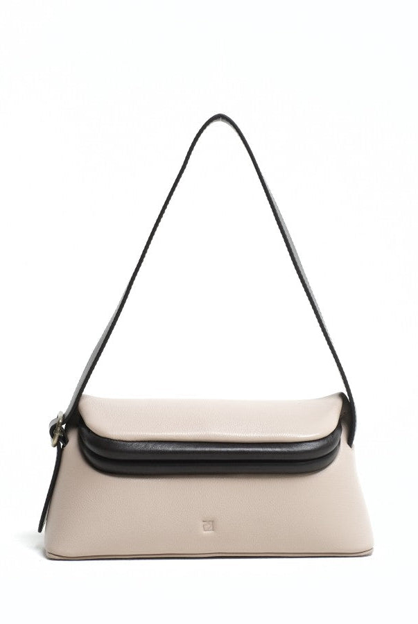 A taupe-colored shoulder bag with a flap closure and an adjustable long strap from purotti, displayed against a plain background.