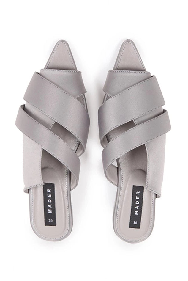 A pair of gray open toe mules with double strap and low heel.