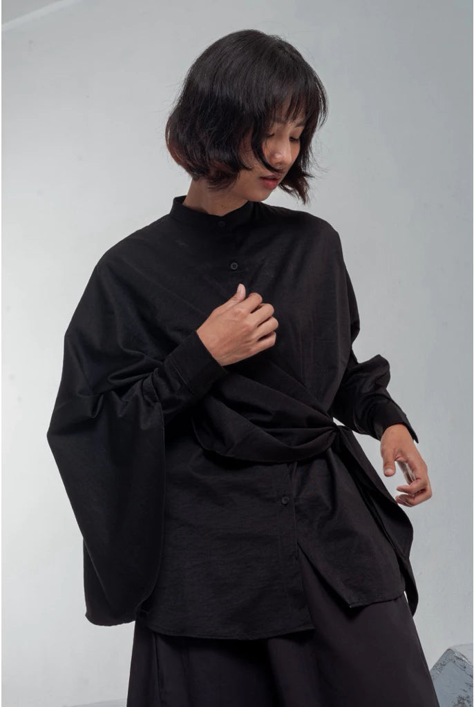 Person wearing a black shirt by Yestoday against a plain background