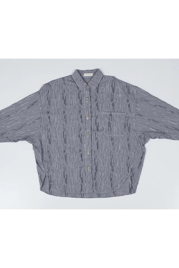 Black and white mini checkered oversized shirt by Yestoday with button details on a light gray background