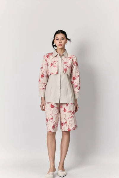 Woman wearing a floral pink shirt by Studio Tui on a white background