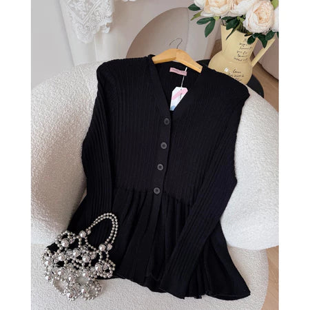 Black cardigan from Haidee Orlin on a white chair