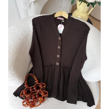 Brown ribbed cardigan from Haidee Orlin with a matching handbag on a white surface