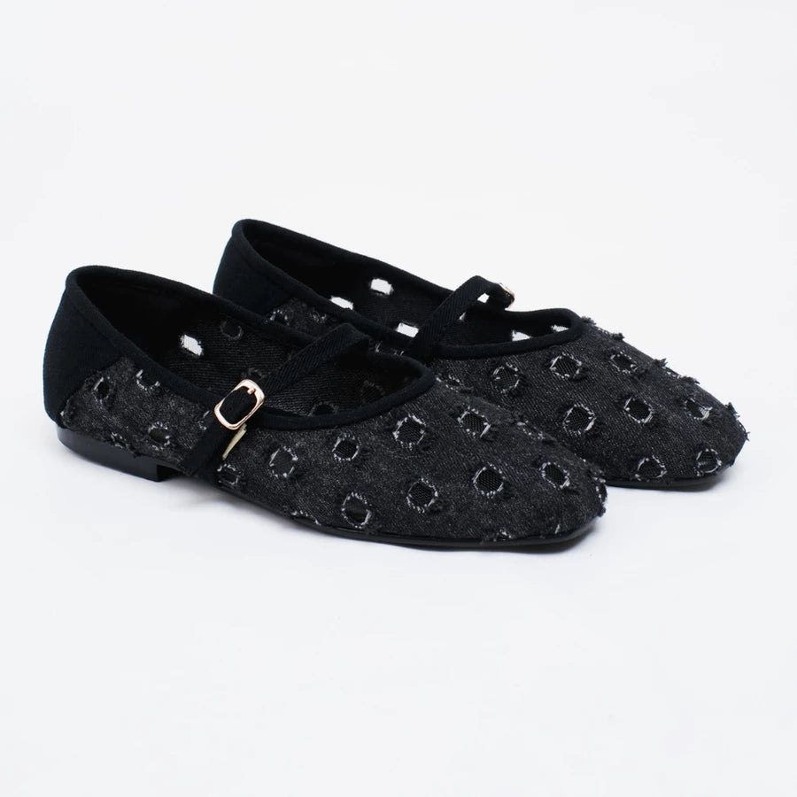 A pair of black flatshoes with a textured, woven circular pattern and a small gold buckle on the strap by Cekhas, shown on a white background.