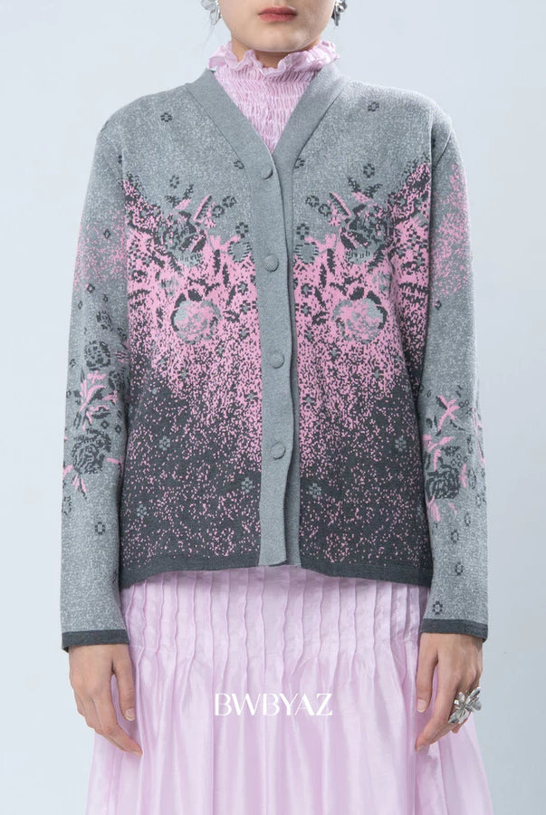 Person wearing a gray cardigan with pink floral patterns by BWBYAZ on a light blue background