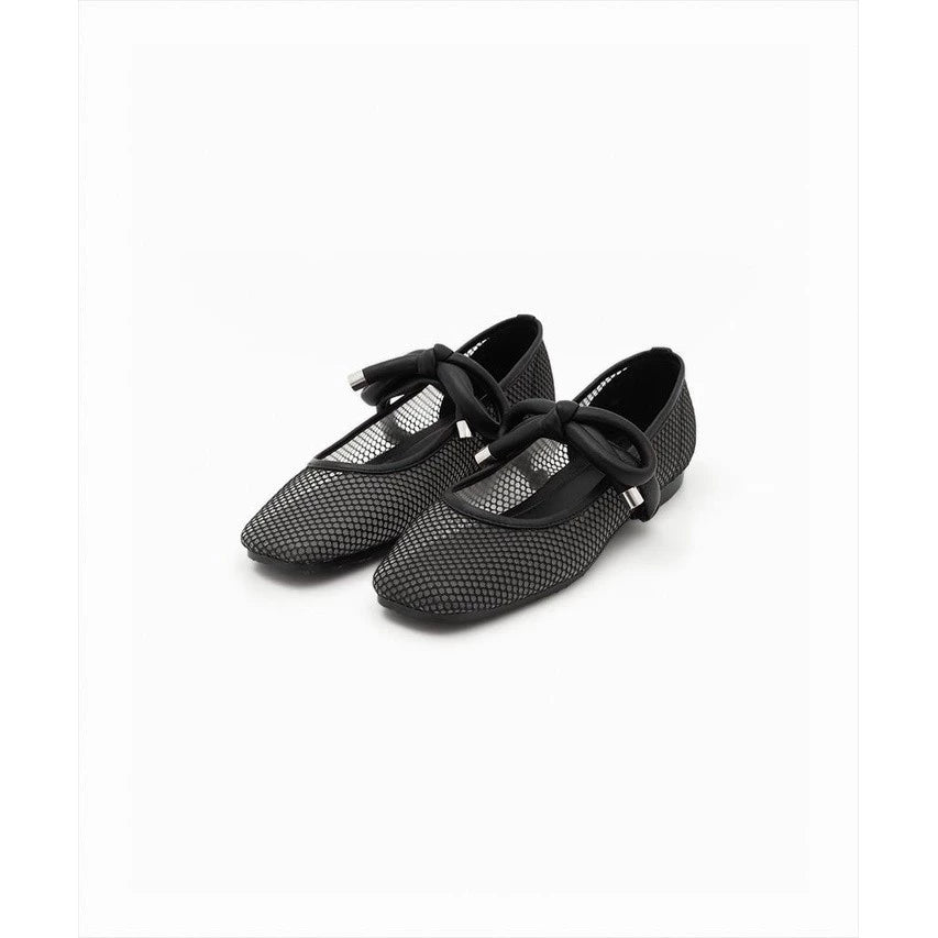 Black mesh shoes by Cajsa with bow details on a white background