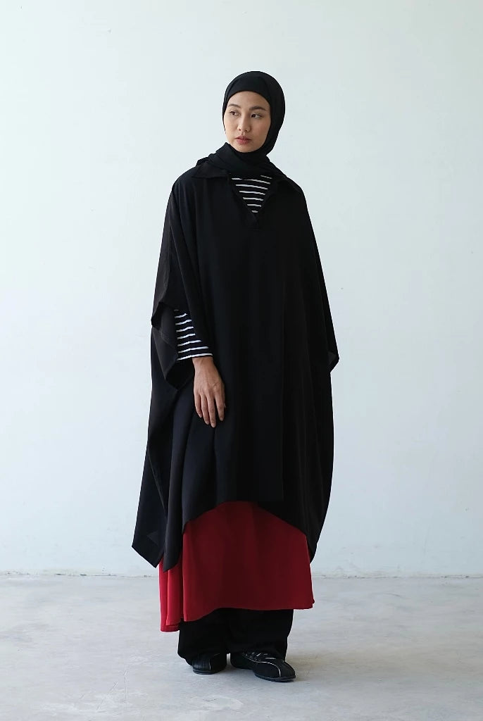 Person wearing a black vest by Rashawl with a white background