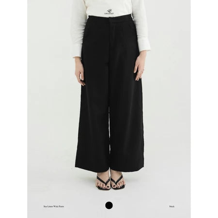 Person wearing black wide-leg pants by Swifter on a white background