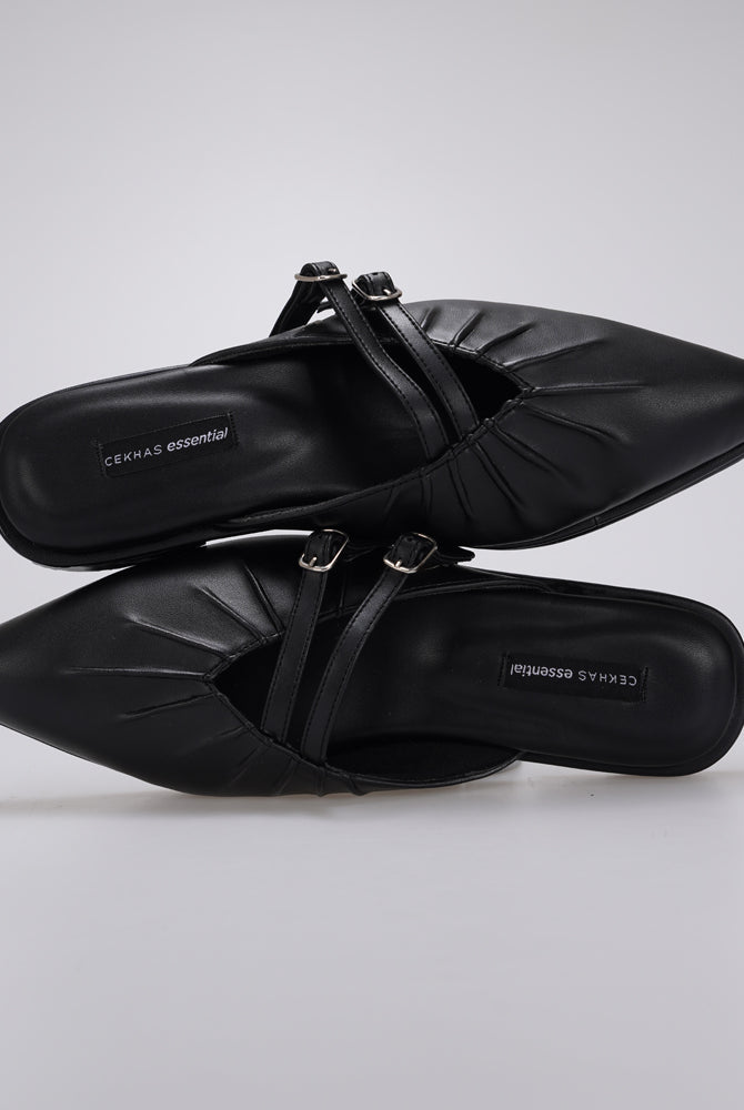 A pair of black pointed-toe mule sandals by Cekhas with double buckle straps, shown from a top-down angle on a light gray background.