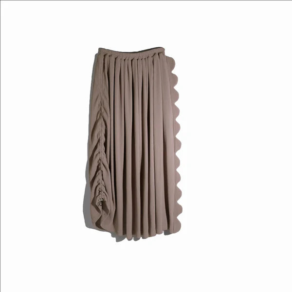 A rose wood-colored knee-length skirt by Rashawl with scallop detailing on the left side and a drawstring waistband on the right side.