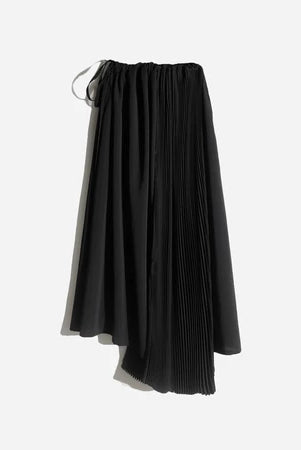 Asymmetrical black pleated skirt by Rashawl for women, featuring a flowy silhouette with a mix of solid and pleated panels, designed with an elastic waistband and drawstring detail.