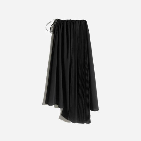 Asymmetrical black pleated skirt by Rashawl for women, featuring a flowy silhouette with a mix of solid and pleated panels, designed with an elastic waistband and drawstring detail.