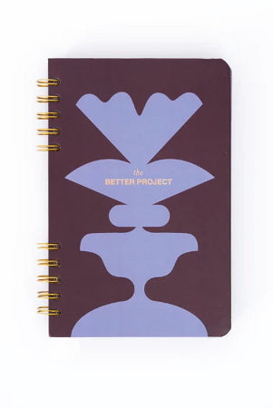 Notebook with purple and dark brown from Muhajir Project design on a white background