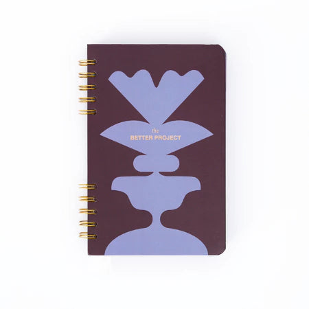 Notebook with purple and dark brown from Muhajir Project design on a white background