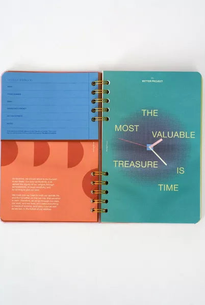 Colorful spiral-bound planner with motivational quote on a white background