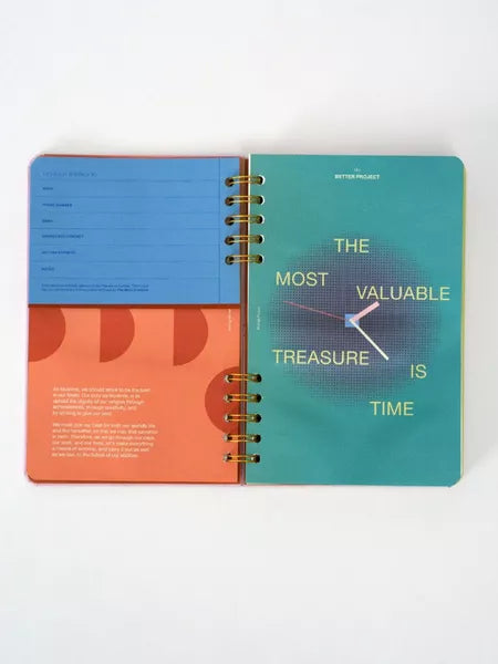 Colorful spiral-bound planner with motivational quote on a white background