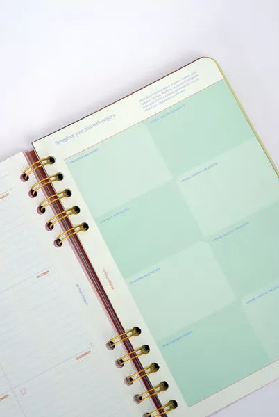 Open planner with a green page on a white background