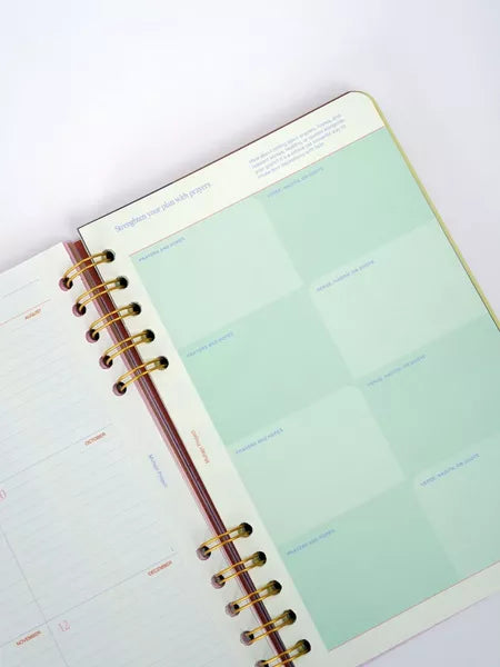 Open planner with a green page on a white background