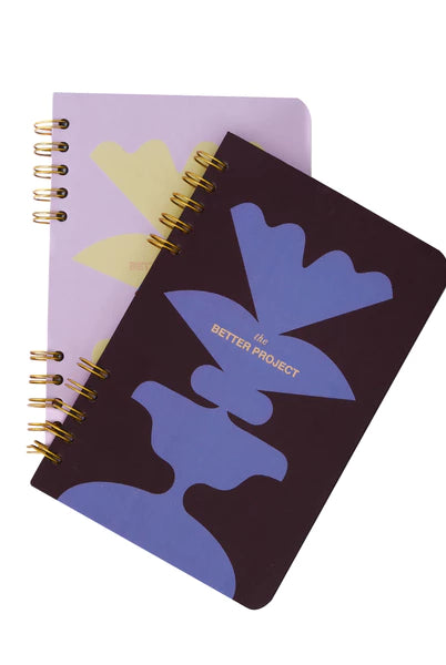Two notebooks with abstract designs on a white background