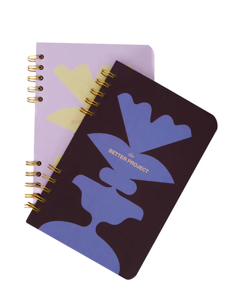 Two notebooks with abstract designs on a white background