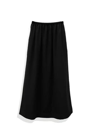A solid black Tsubaki Silk Skirt by Rashawl with a long length and elastic waistband.