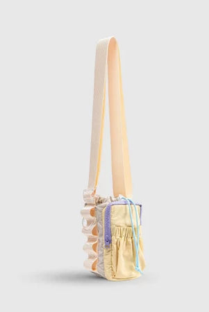 Small handbag with a strap from Muhajir Project on a light gray background