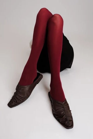 Red tights and brown Vonee Mules flat shoes by Cekhas on a white background