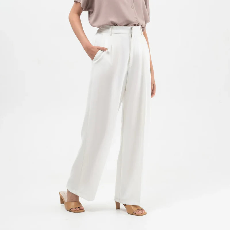 Person wearing broken white wide-leg culotte pants on a white background