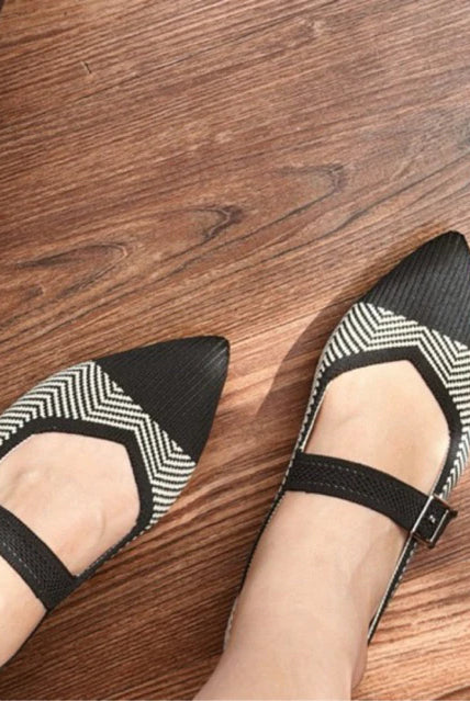Black and white patterned flatshoes by Tutu Toe on a wooden floor