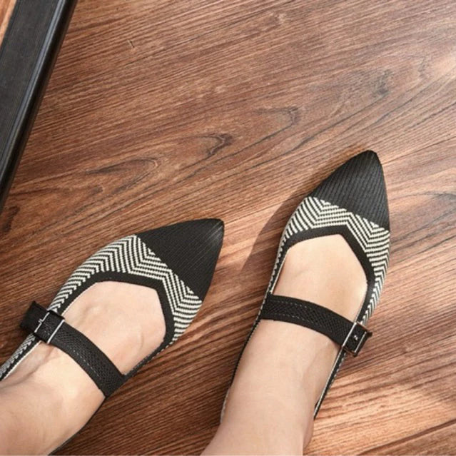 Black and white patterned flatshoes by Tutu Toe on a wooden floor
