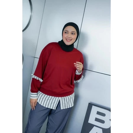 Woman wearing a red sweatshirt by Abame.