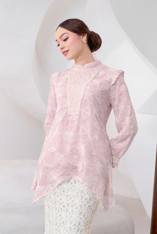 Woman wearing a light pink blouse by Kasa Heritage with a white background
