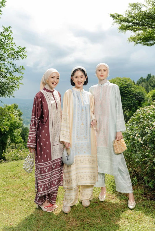 Three women in Zainara Set from Haidee Orlin standing outdoors with trees and grass in the background